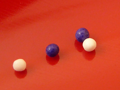 Two dark and two white little candies (close-up)