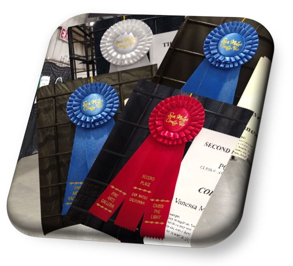 WIte, red, and blue award ribbons from a fair
